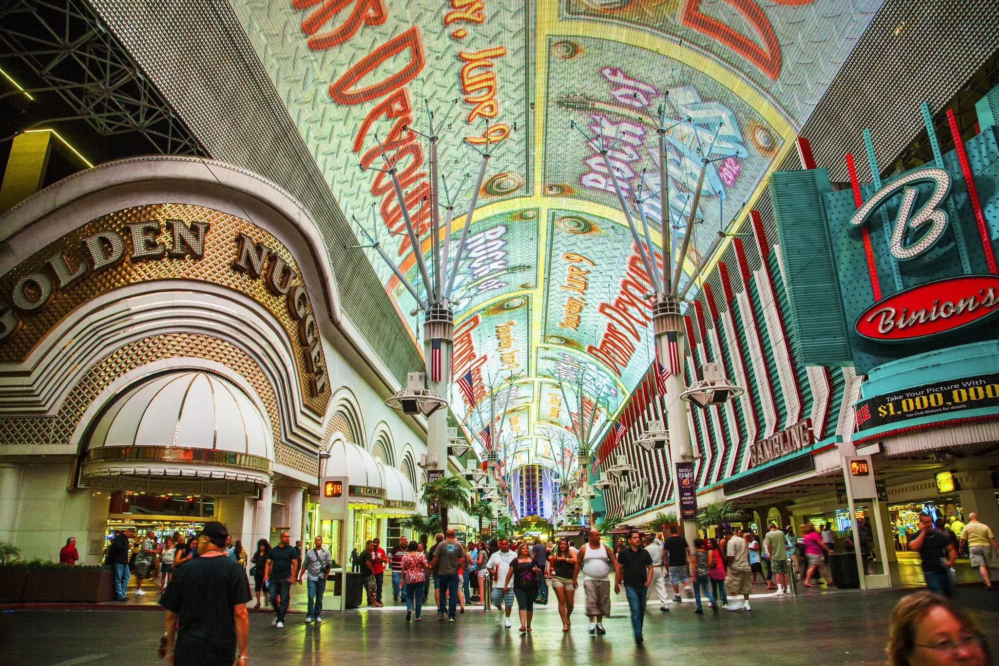 A wide shot of the people and casinos on Fremont St