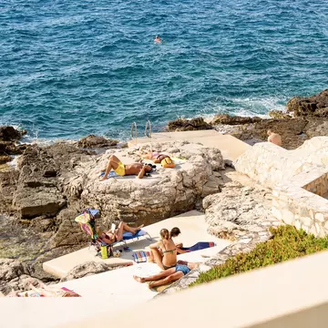 Visitors relaxing under the sun on Brioni beach, Pula.