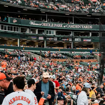 A crowd of baseball fans in the stands at Camden Yards Stadium