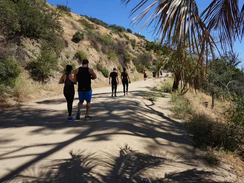 People walk along a hiking trail at Runyon Canyon Park in the Hollywood Hills.