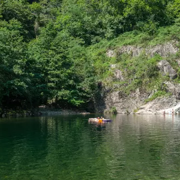 River Cannobino with bathing tourists near the church of Saint Anna in Valle Cannobina near Cannobio.