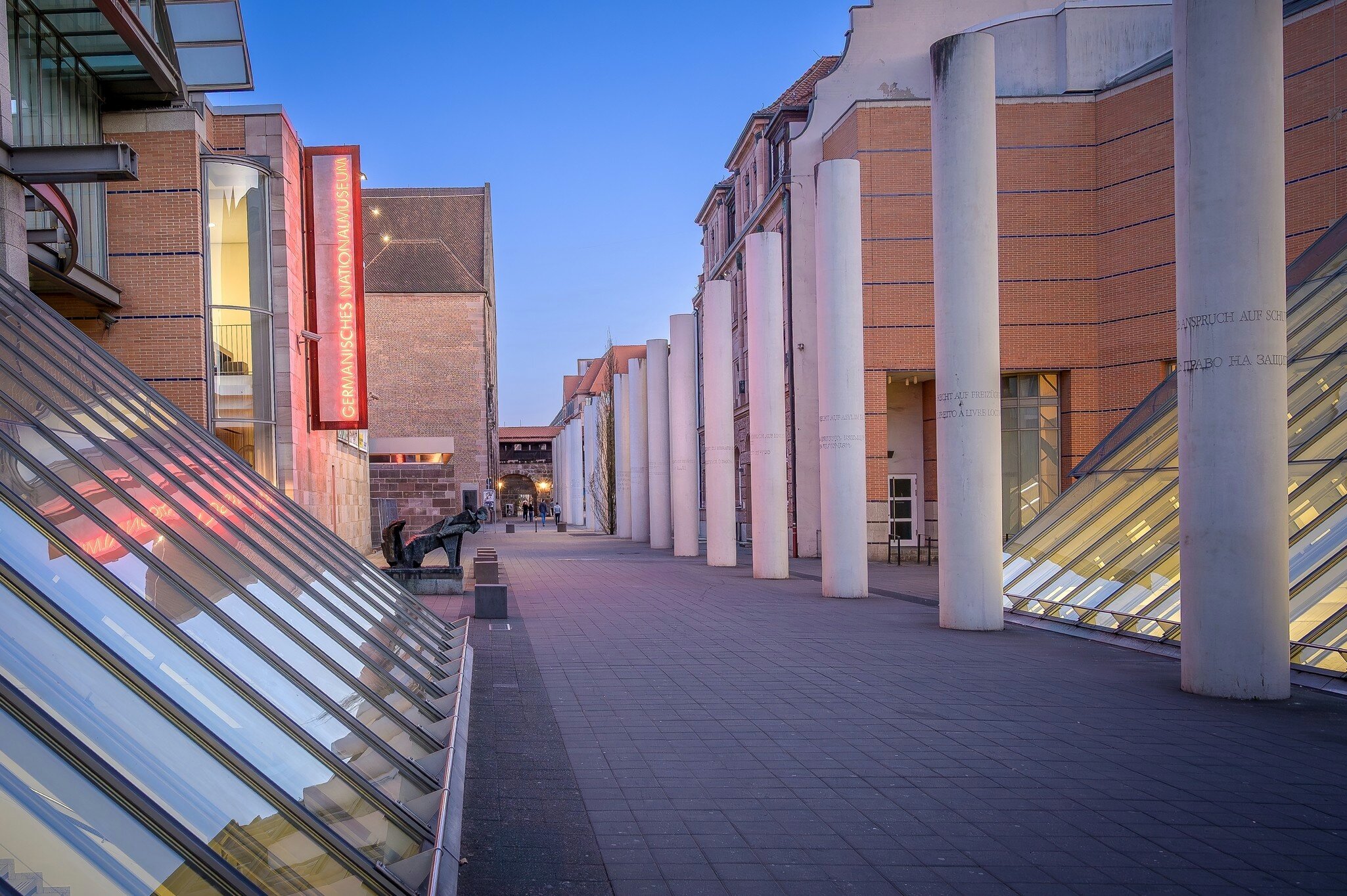 View of the architectural design of the Germanisches Nationalmuseum in Nuremberg during twilight hours.