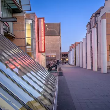 View of the architectural design of the Germanisches Nationalmuseum in Nuremberg during twilight hours.