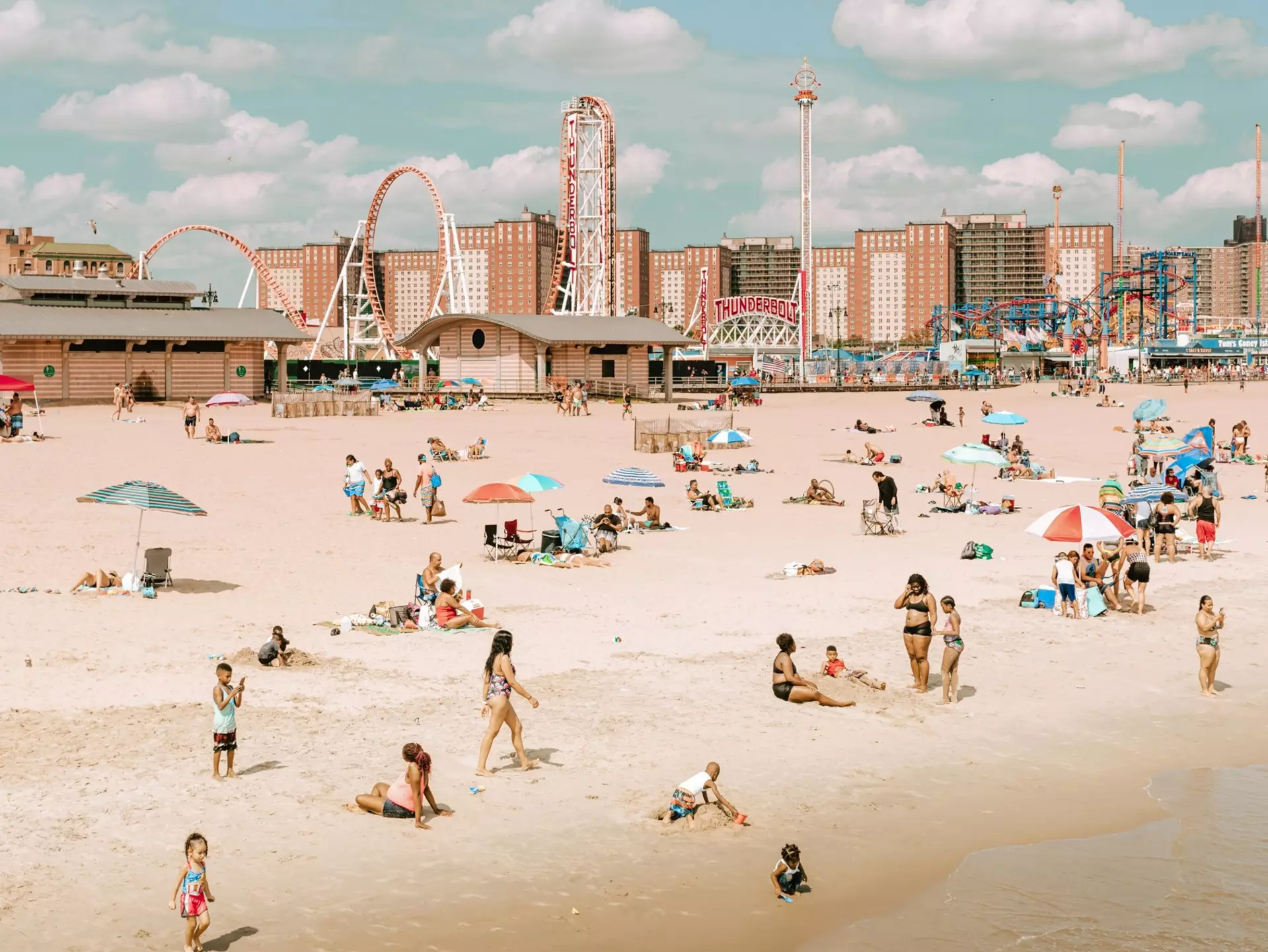 Coney Island's amusement parks stand tall behind the beach. Iryna Horbachova/Shutterstock