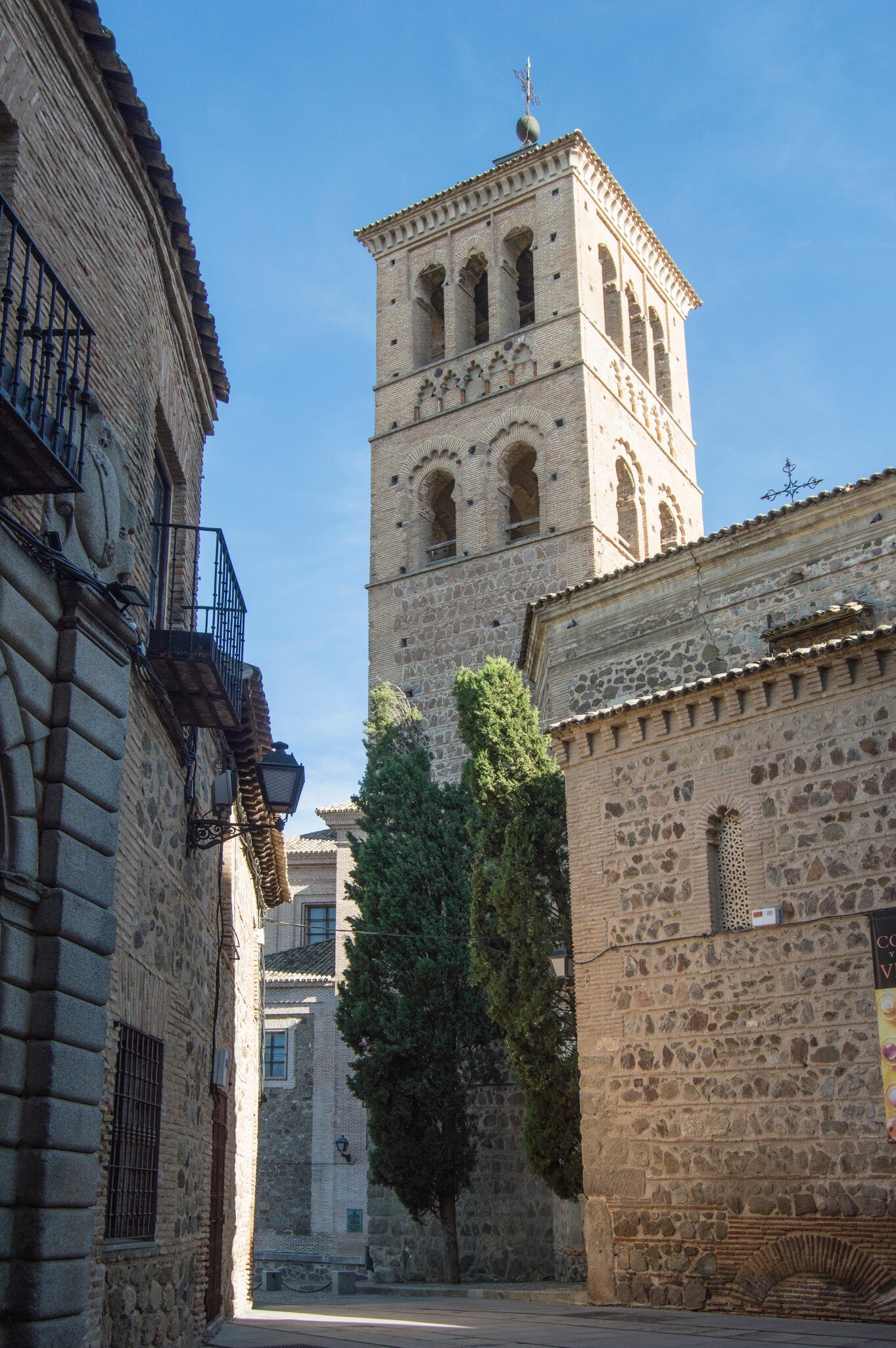 View down a street of the Mudejar tower of the Iglesia de Santo Tomé in Toledo, Spain.