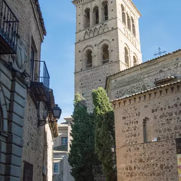 View down a street of the Mudejar tower of the Iglesia de Santo Tomé in Toledo, Spain.