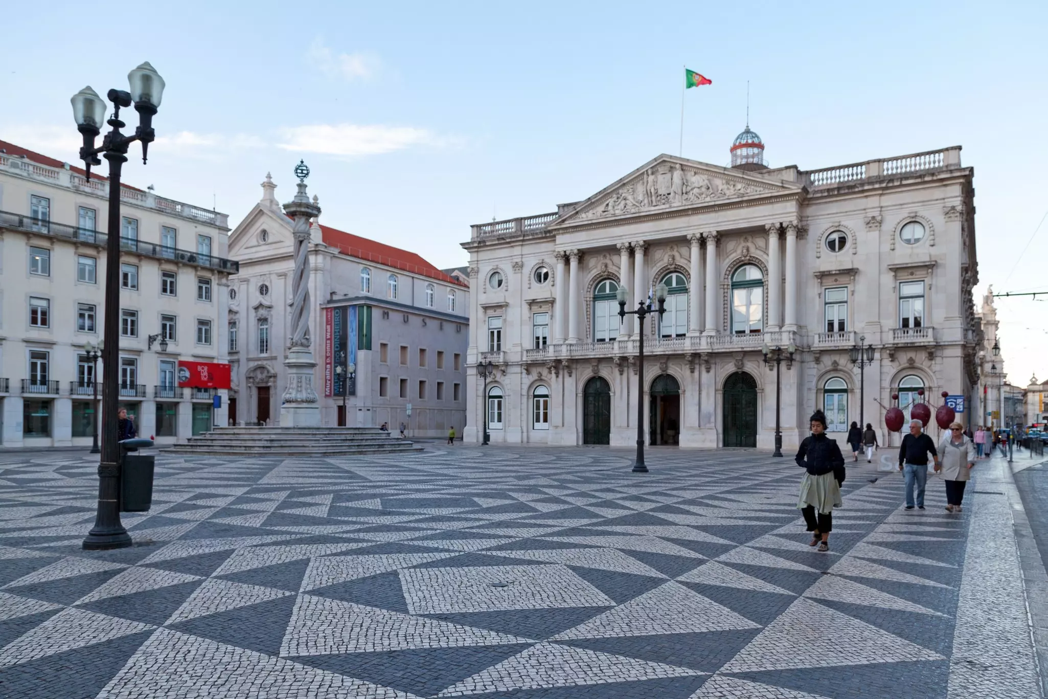 A large museum building on the edge of a square with black and white tiling.