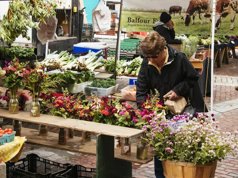 Flower stall at a farmers market .