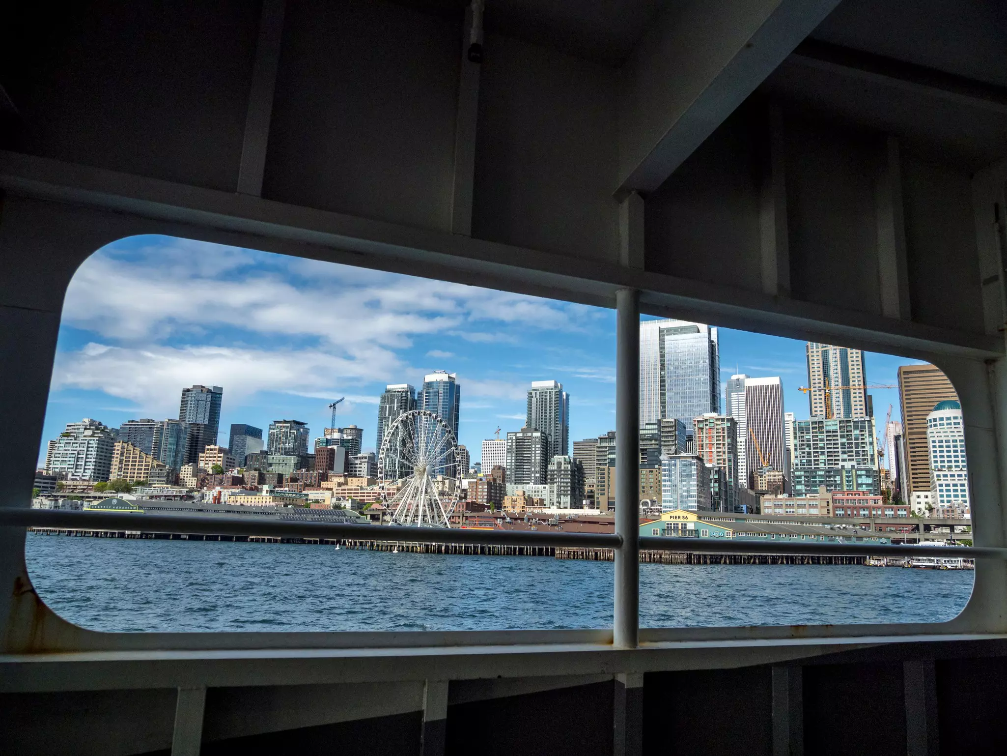 Seattle skyline viewed through the window of a ferry on Elliott Bay in Puget Sound.