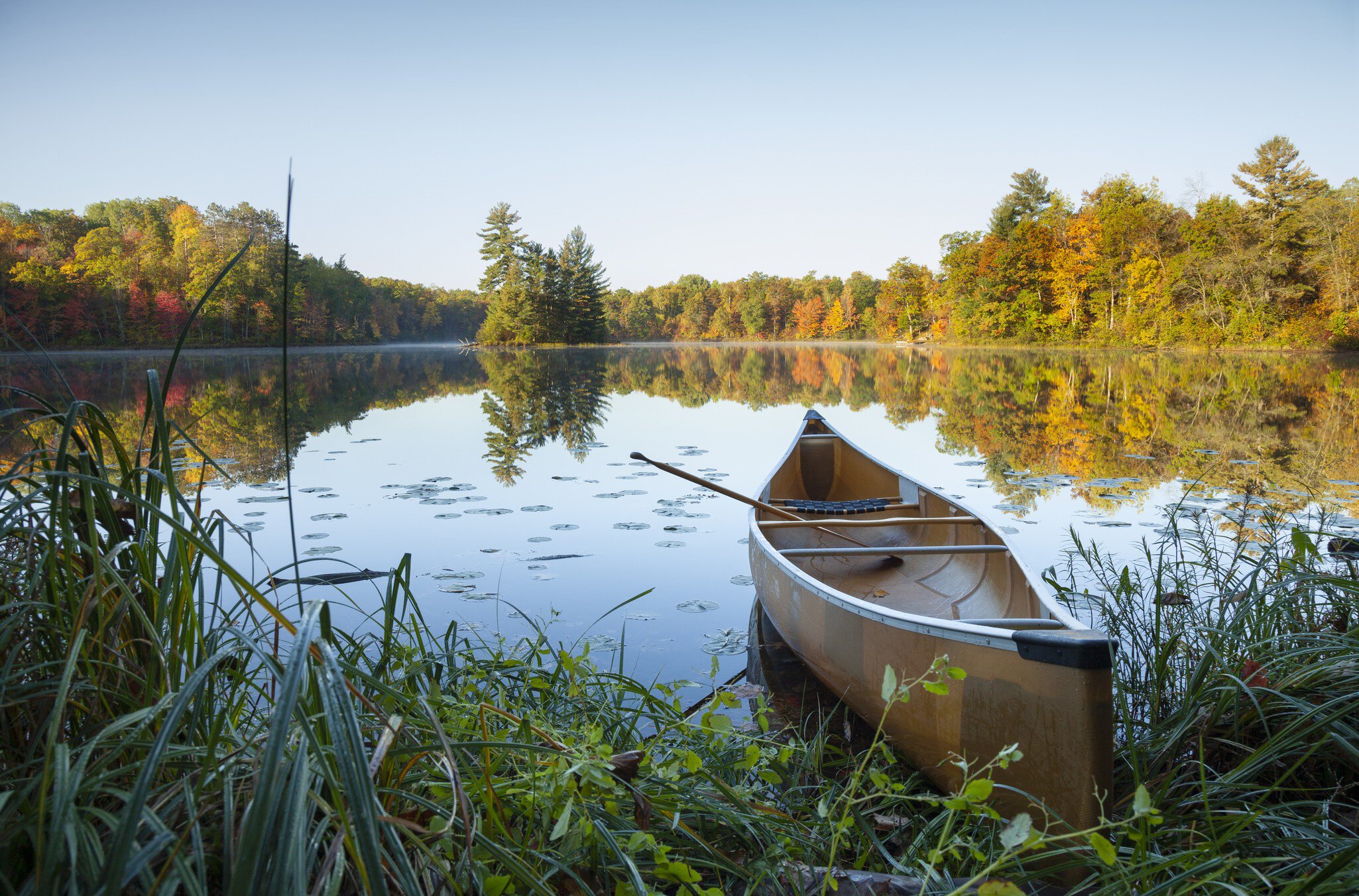 Canoe with paddle on shore of beautiful lake with island in northern Minnesota at sunrise
1358470404
fall, scenery