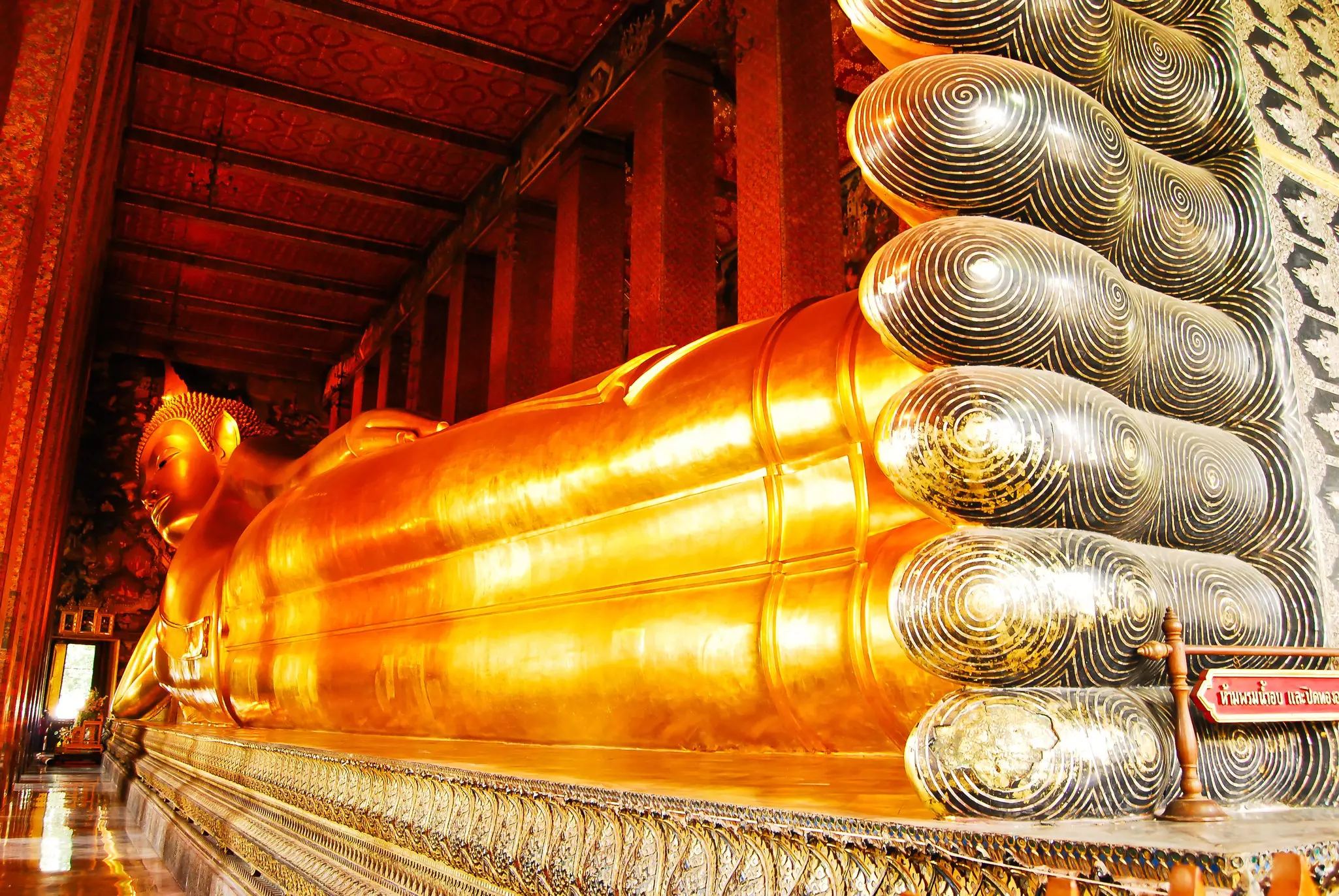 A large golden Buddha statue lying on its side