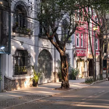 Morning light hits the facades of the art deco style buildings on a street in the trendy neighborhood of La Condesa, in Cuauhtemoc borough of Mexico City