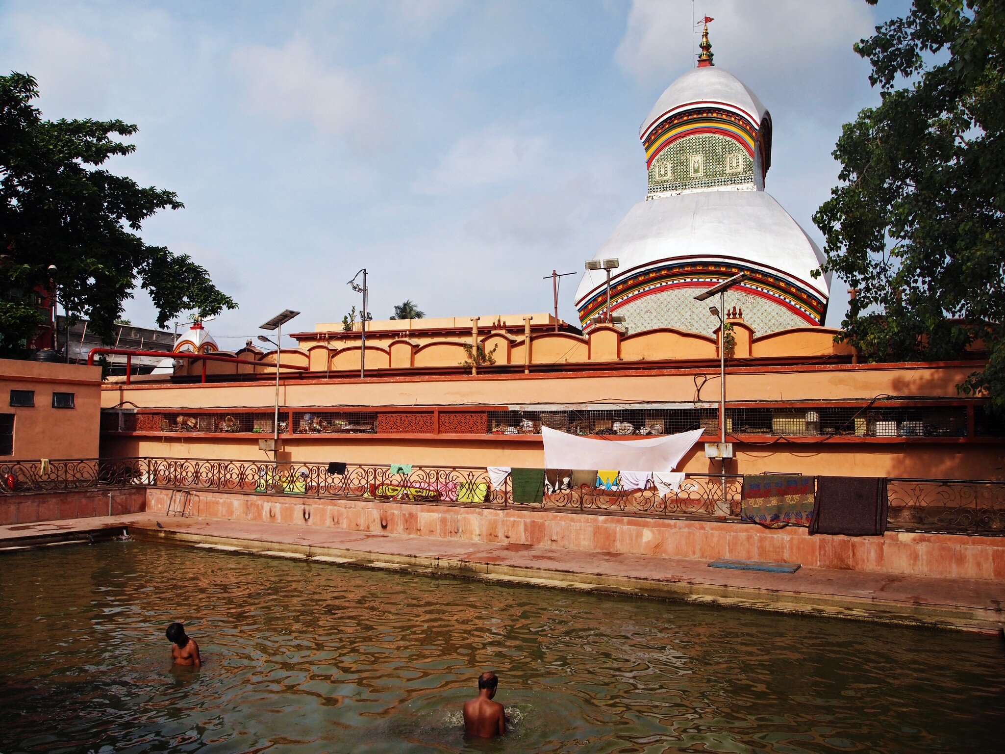 Bathing outside the Kalighat Kali Temple in Kolkata, West Bengal, India.