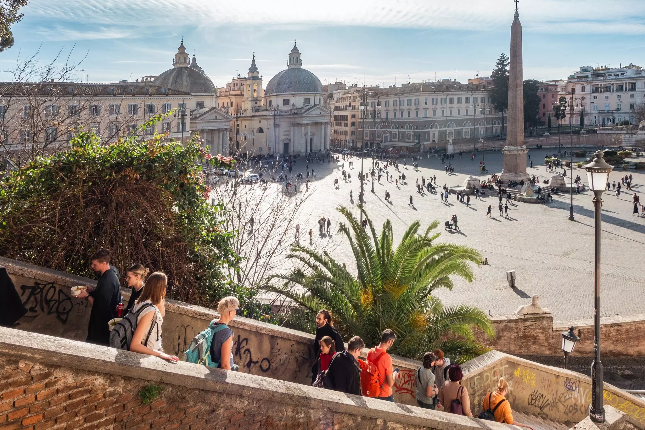 A panoramic view of Piazza del Popolo with tourists.