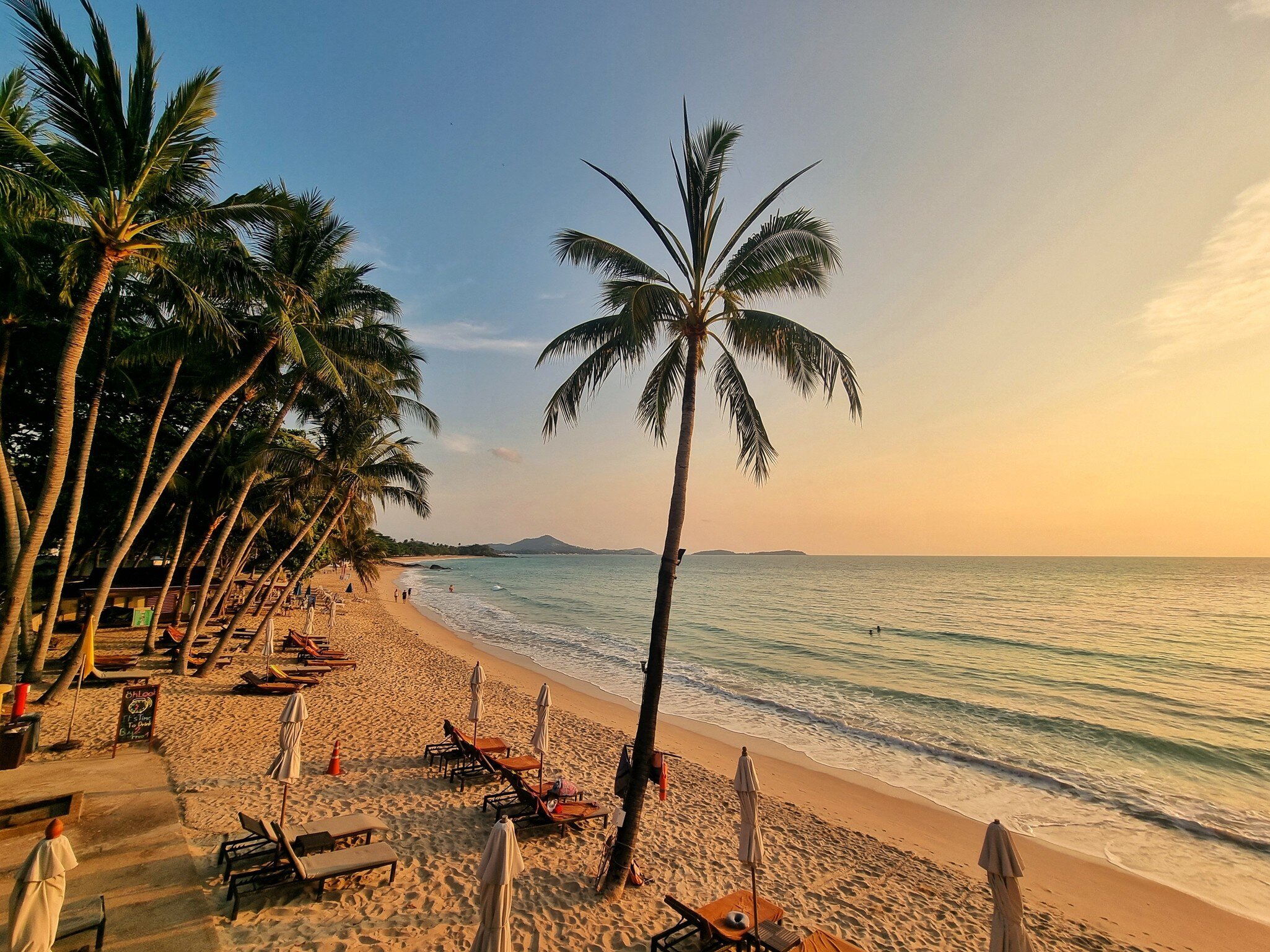 View at beach with palm trees and beach chair, Chaweng Beach, Samui District, Surat Thani, Thailand. 