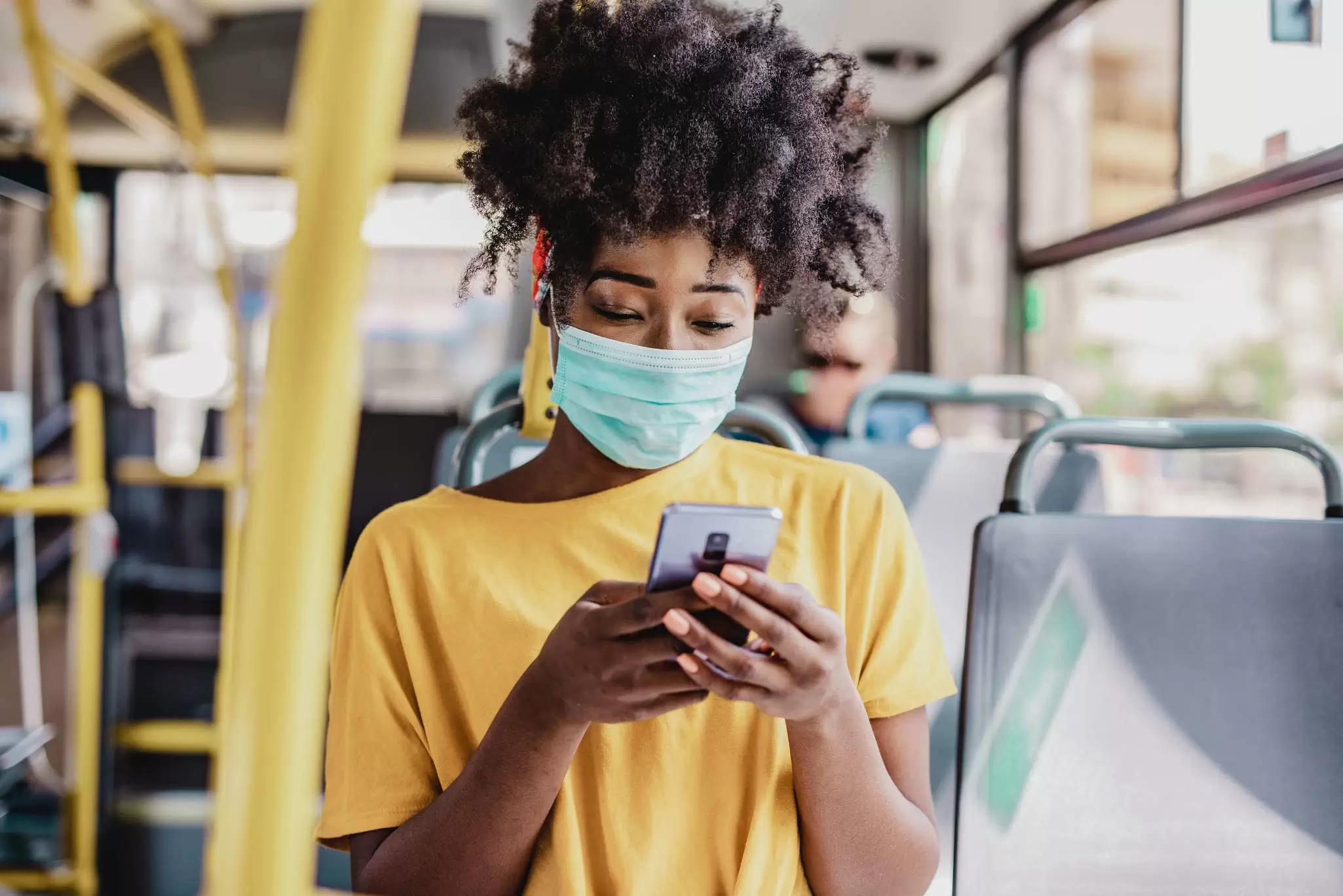 A masked commuter traveling during the pandemic