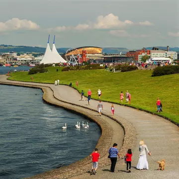 People walking along Barrage and Walkway at Cardiff Bay, Cardiff, Wales.
