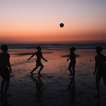 Young men kicking a soccer ball at a beach in Casablanca. Morocco. Andrea Vilchez