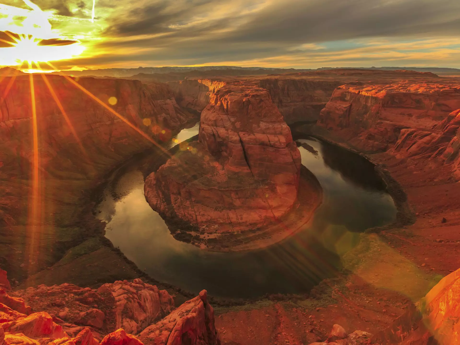 Horseshoe Bend during a vibrant sunset. 
508499104
Tall - High, Red, Journey, USA, Grand Canyon, Famous Place, National Park, North America, Curve, Rock - Object, Page - Arizona, Colorado River, River, Outdoors, Sunlight, 103626, Back Lit, Business Travel, Scenics - Nature, Horseshoe Bend - Colorado River, Sky, Cliff, Lake Powell, Ravine, Landscape - Scenery, Arizona, Extreme Terrain, Landscape, Grand Canyon National Park, Nature, Photography, Wilderness Area, Business Finance and Industry, Drinking Water, Horseshoe Bend, Red Rocks State Park - Arizona, Travel Destinations, Horizontal, Travel, Red Rocks, Hiking, No People, Glen Canyon National Recreation Area, Sunset, Reflective, Desert, Reflection, Tail Light, Canyon, Sunbeam, Lens Flare, Star Shape, Copy Space