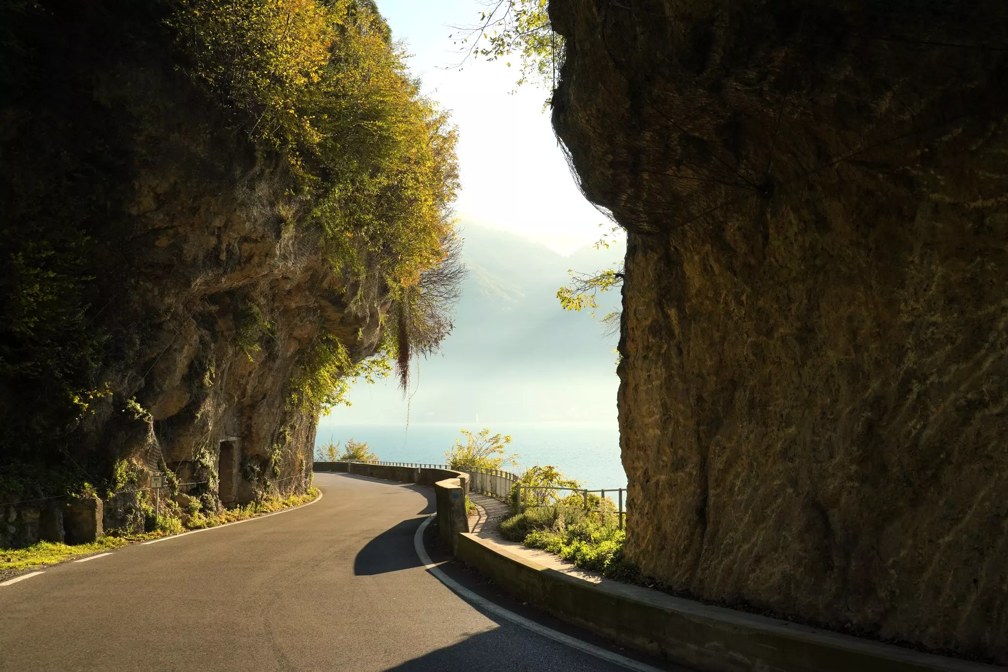 Autumn view of a road around Lake Iseo. Province of Bergamo, Lombardy, Italy.