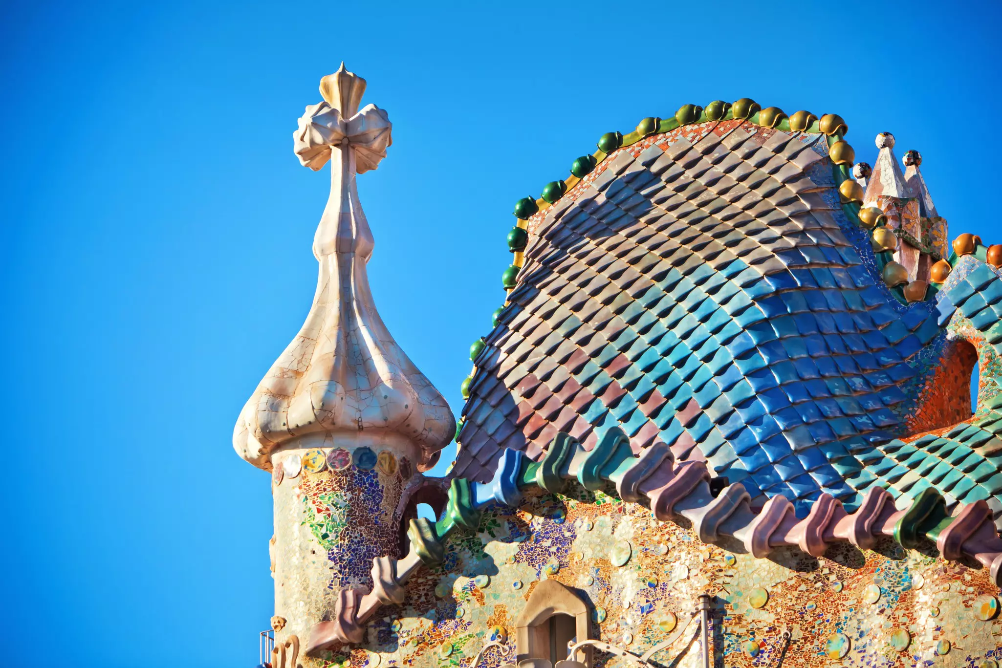 The roof of a building with elaborate ornament and polychrome tiles.