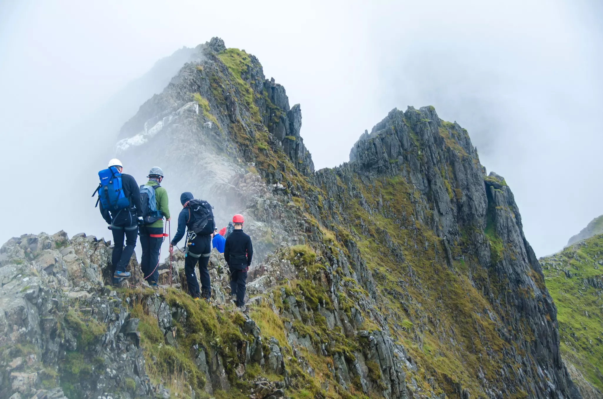 A group of climbers making their way across Crib Goch, a route to the Mount Snowdon summit famous for its steep drops
