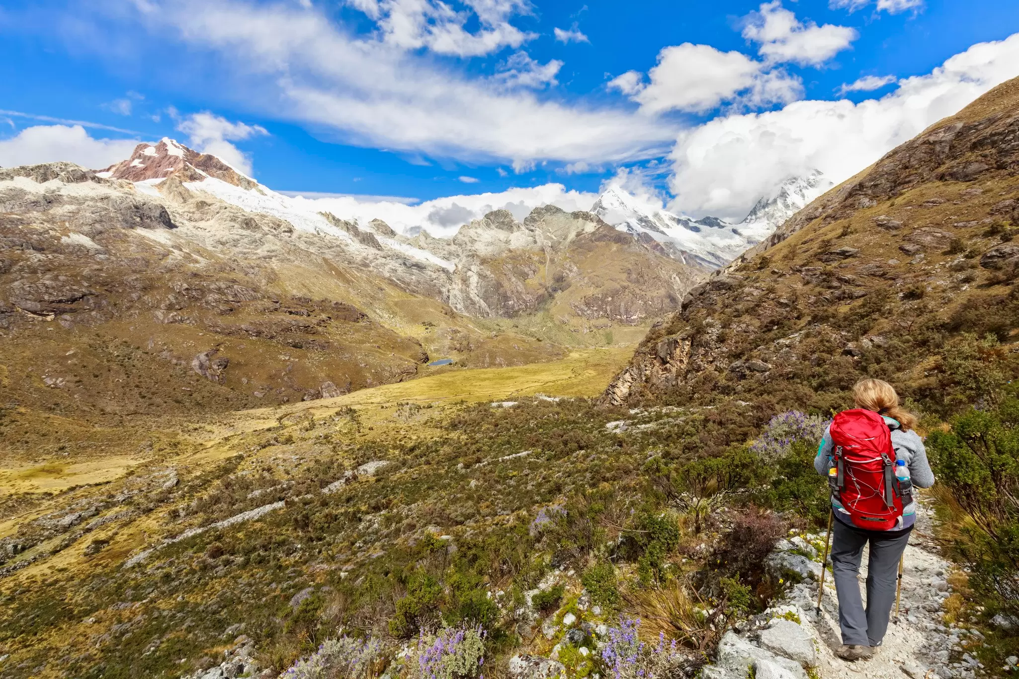 A hiker surrounded by mountains in Peru's Huascaran National Park. 