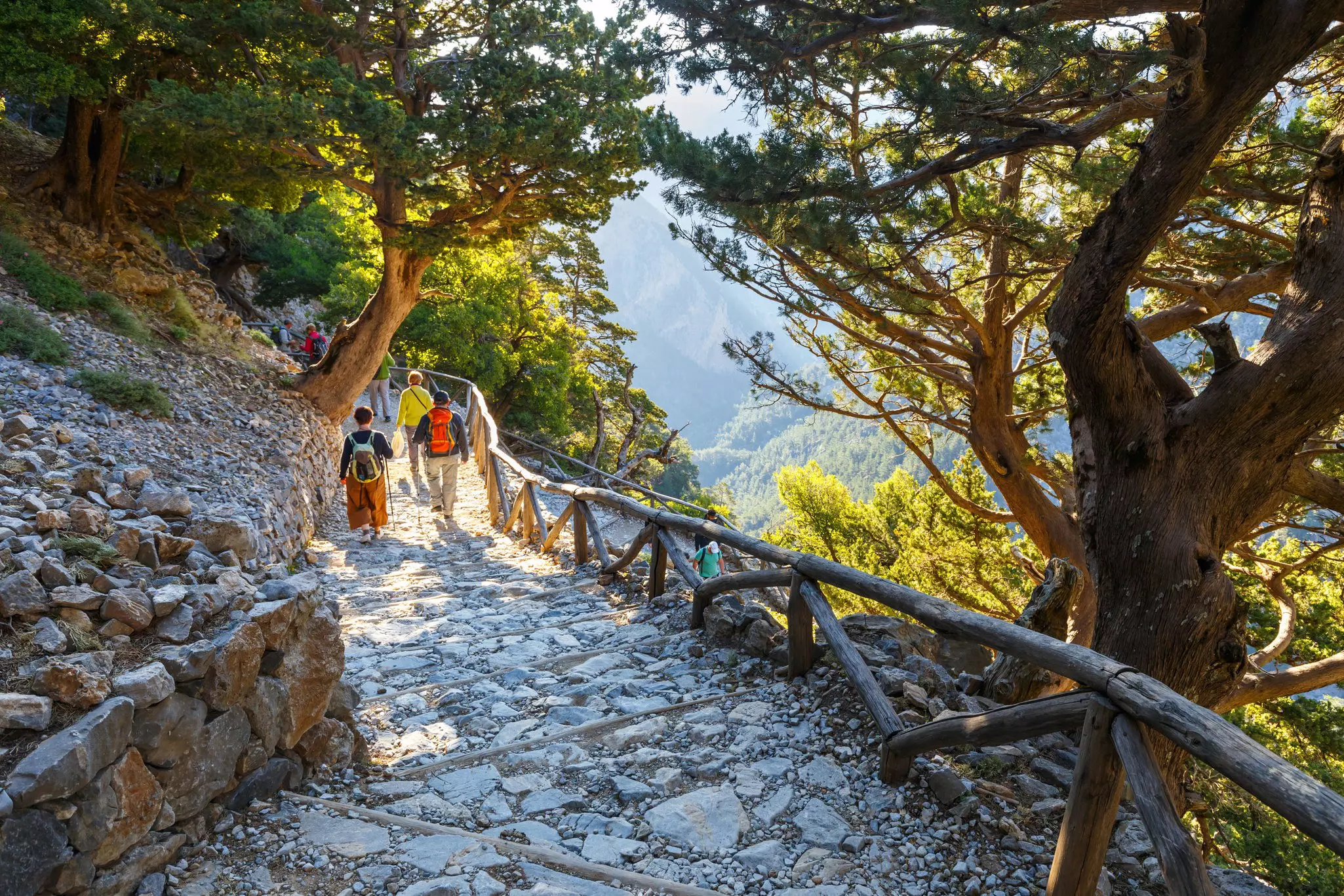 Hikers descend a staircase at the Samaria Gorge, Crete.