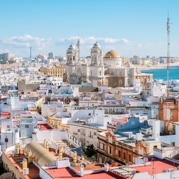 Aerial panoramic view of the old city rooftops and Cathedral de Santa Cruz in the afternoon from tower Tavira in Cadiz, Andalusia, Spain, License Type: media, Download Time: 2025-10-15T16:09:15.000Z, User: katelyn.perry_lonelyplanet, Editorial: false, purchase_order: 65050 - Digital Destinations and Articles, job: wip, client: wip, other: Katelyn Perry