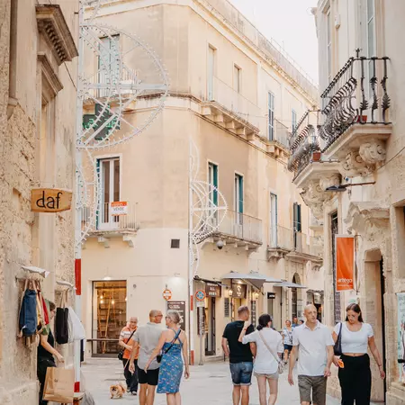 People walking through an old town center