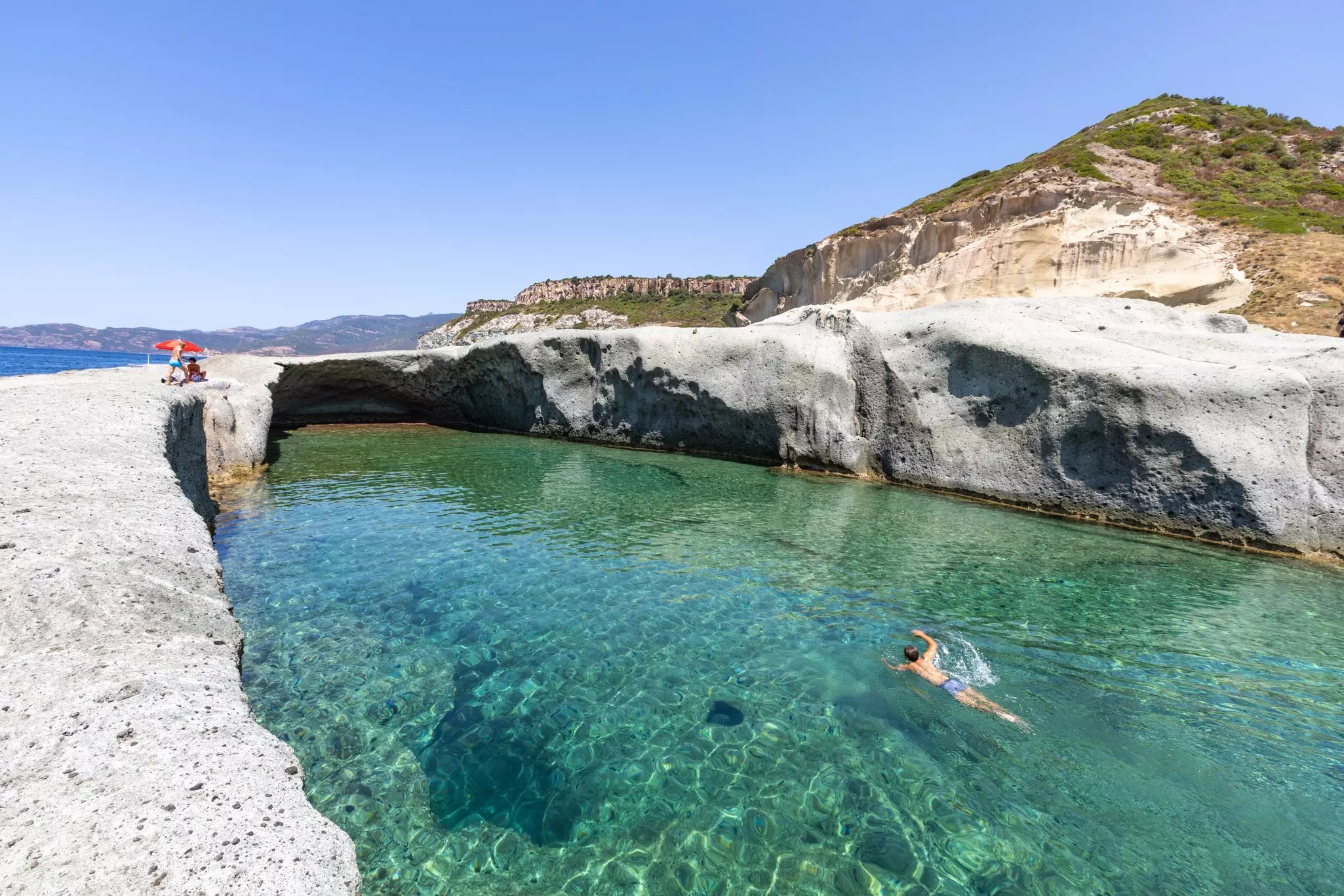 Cane Malu, a man swims in the beautiful natural pool carved into the rock on the west coast of Sardinia, Bosa, Oristano, Italy, Europe, License Type: media, Download Time: 2025-02-13T14:45:24.000Z, User: catalinaaragon, Editorial: false, purchase_order: 56530 - Guidebooks, job: Global Publishing WIP, client: Sardinia 8, other: CA