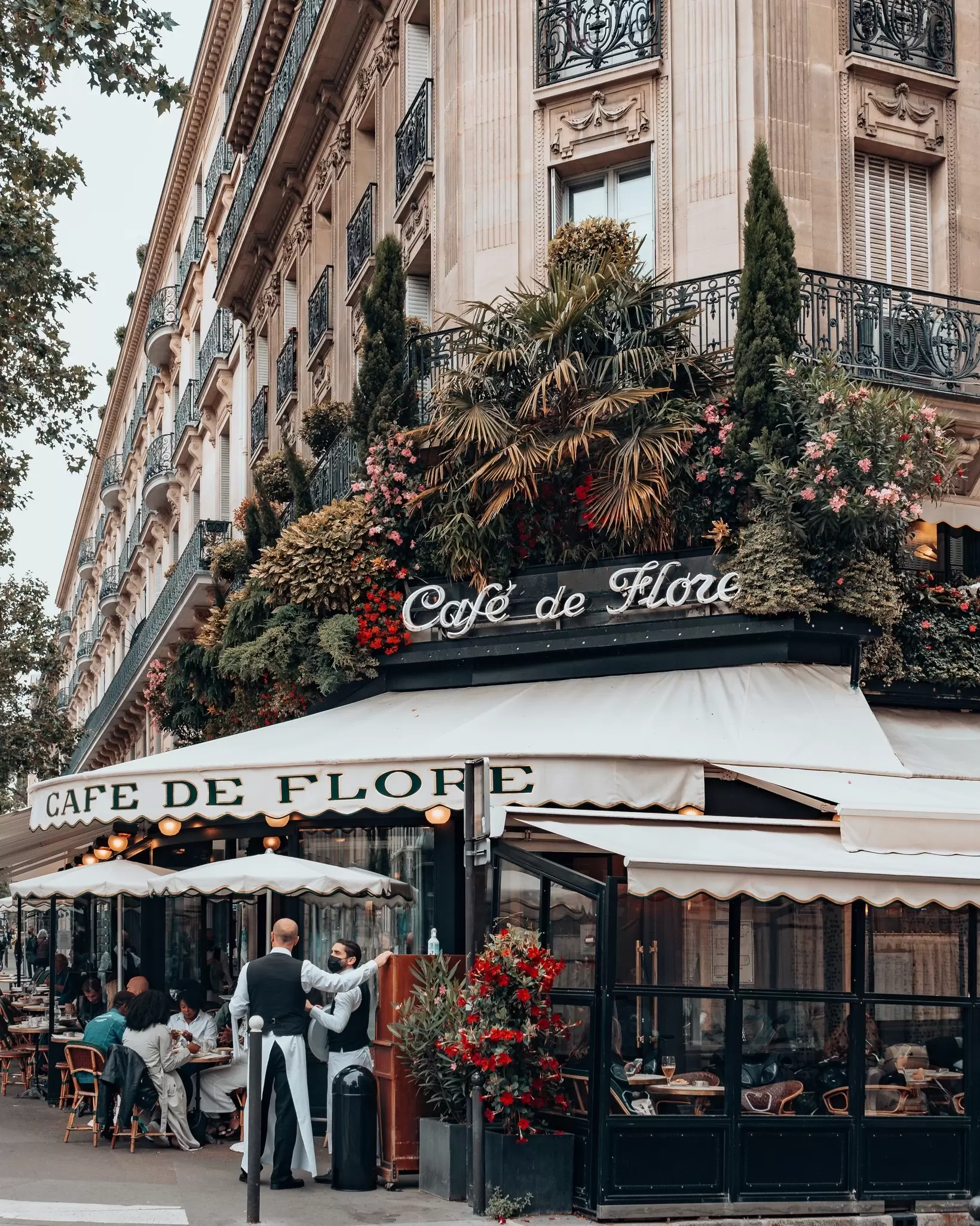 Customers and waiters outside the Café de Flore in the St-Germain neighborhood of Paris
