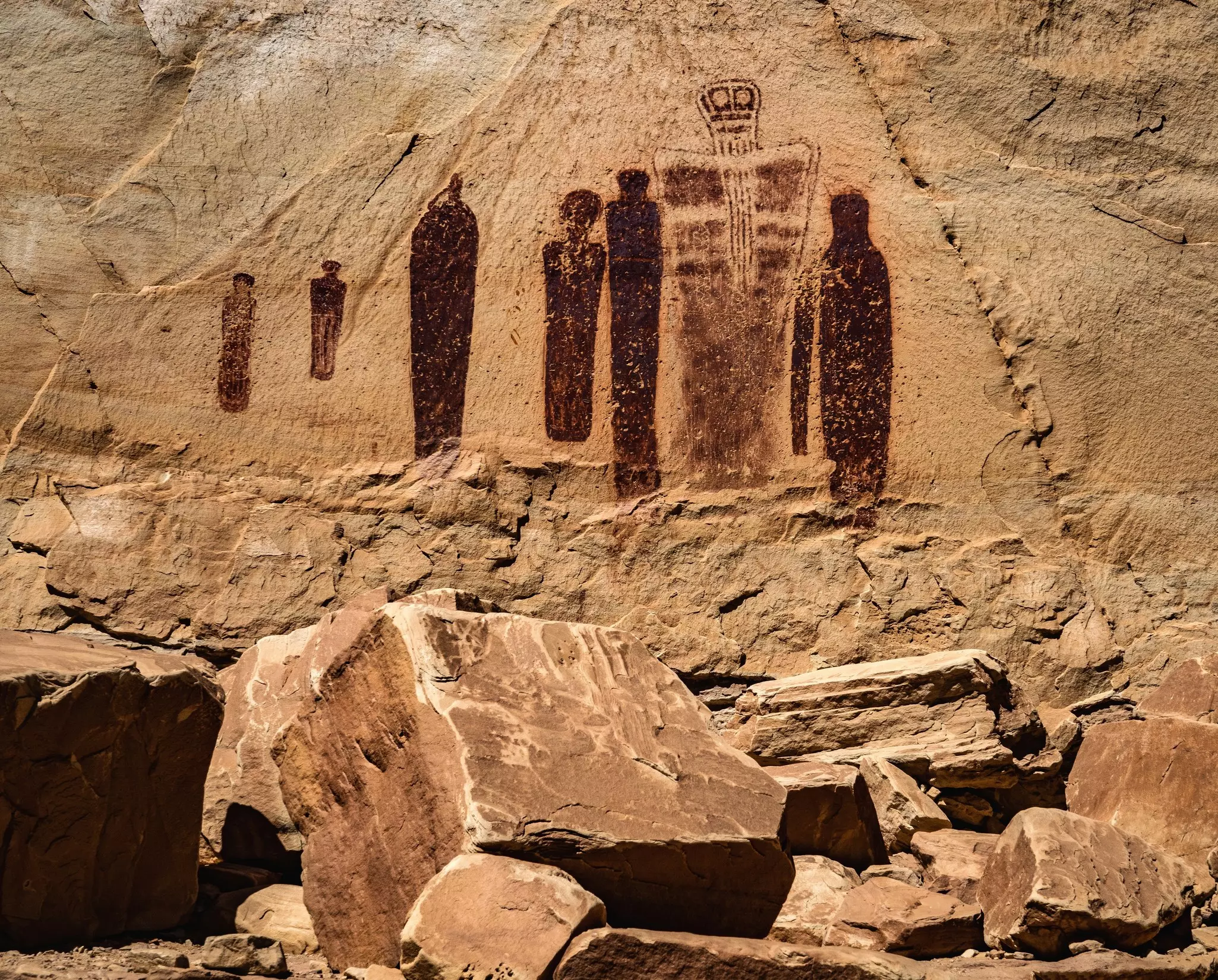 Pictographs of human forms on a rock canyon in Canyonlands National Park.