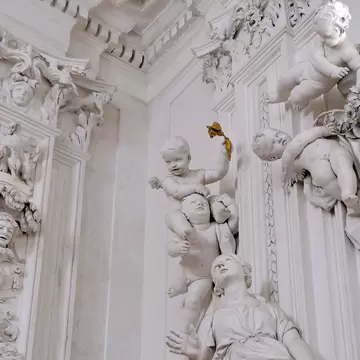 Sculpture of a lady and angels in the Oratorio di San Lorenzo.