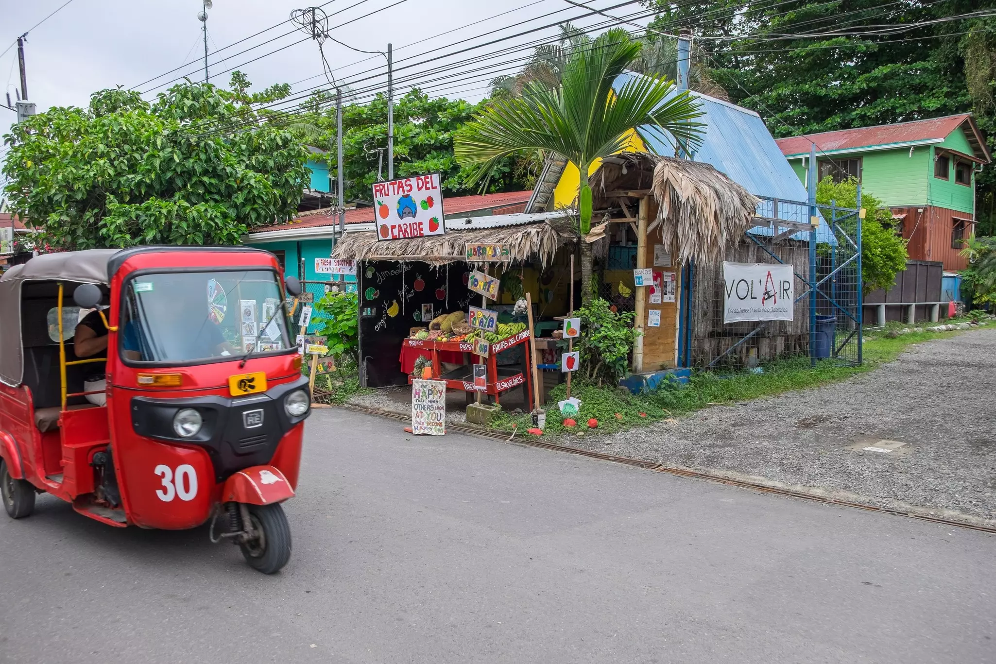 Urban scene and tuc tuc driving in the streets of Puerto Viejo de Talamanca