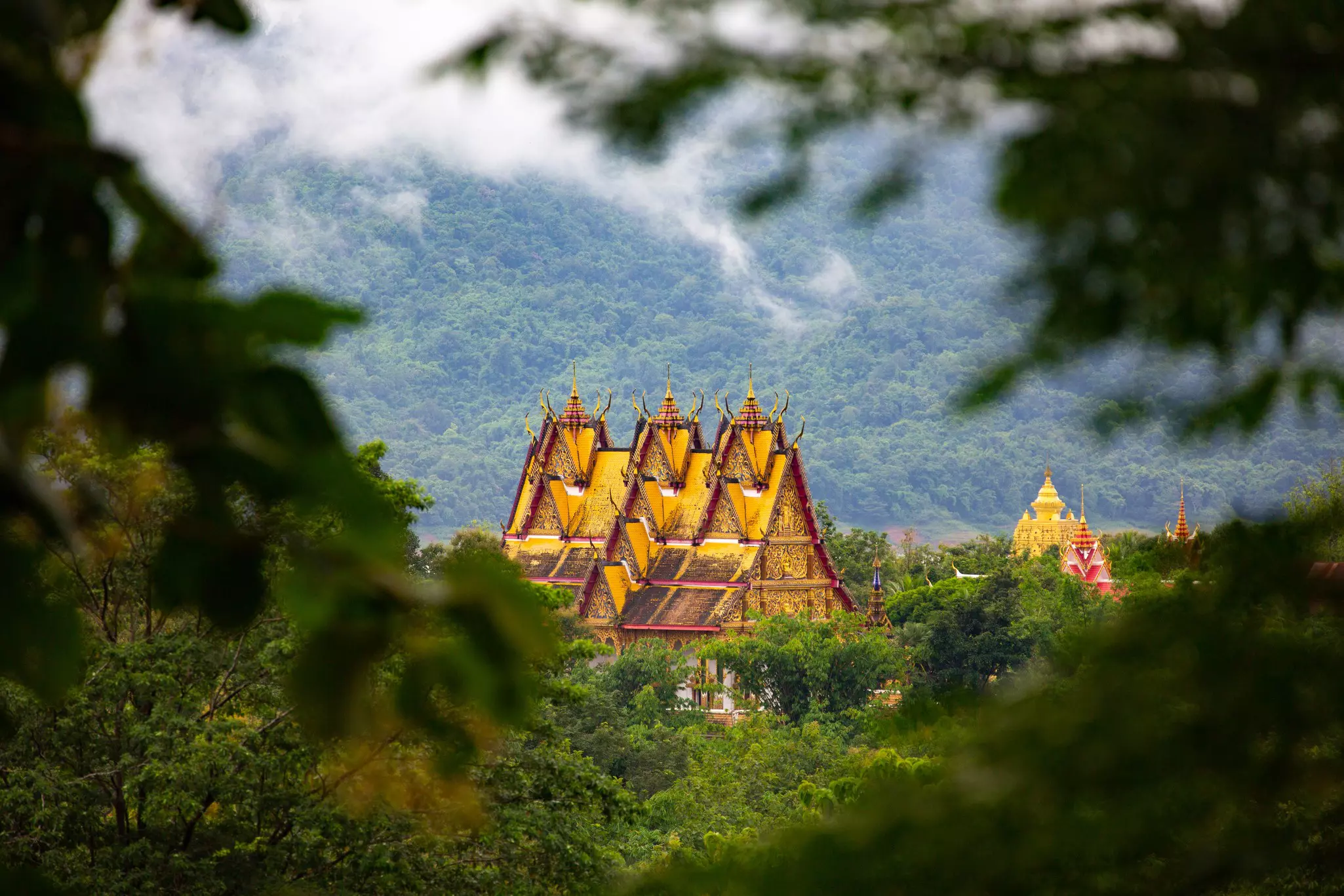 Wat Wang Wiwekaram viewed through trees in Sangkhlaburi, Thailand