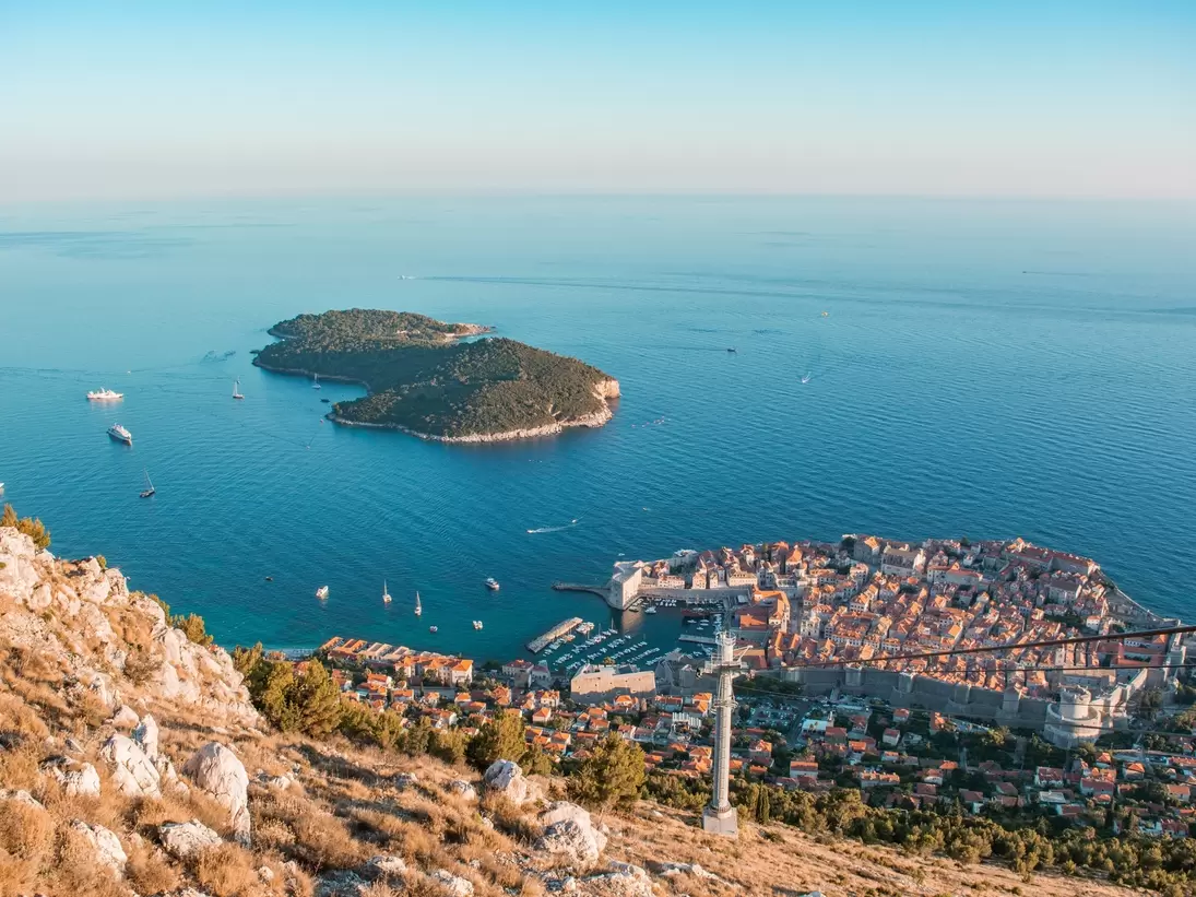 Old town of Dubrovnik with Lokrum island on background with red roofs; Shutterstock ID 151850840; Your name (First / Last): Josh Vogel; Project no. or GL code: 56530; Network activity no. or Cost Centre: Online-Design; Product or Project: 65050/75...