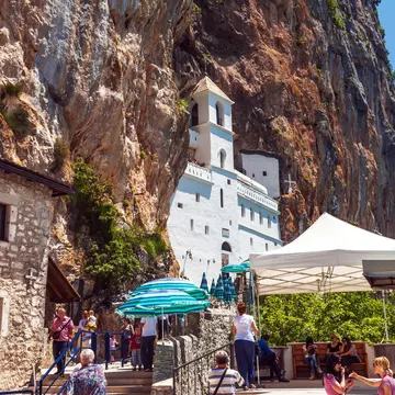Danilovgrad, Montenegro - June 4, 2012: Tourists visit to Ostrog - Serbian Orthodox monastery in Montenegro, located in mountains 15 km from Danilovgrad town. Founded in the XVII century.