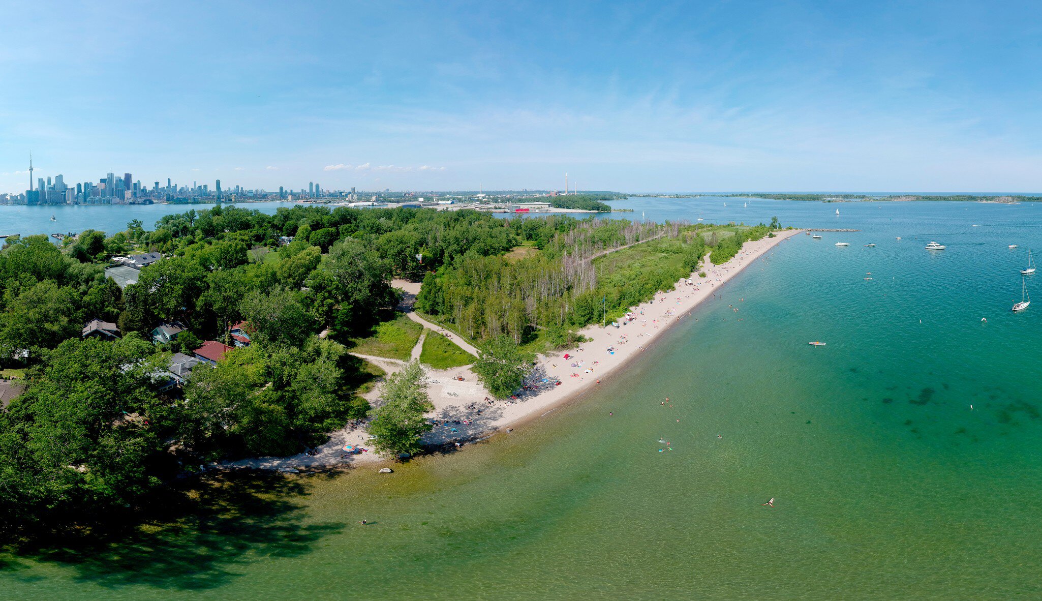 Toronto Central Islands and Ward's Island Park beach, Ontario, Canada, aerial view from top at sunny greenery and sandy coast with boats, people swimming at summer. Popular tourist location.