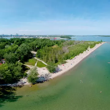 Toronto Central Islands and Ward's Island Park beach, Ontario, Canada, aerial view from top at sunny greenery and sandy coast with boats, people swimming at summer. Popular tourist location.