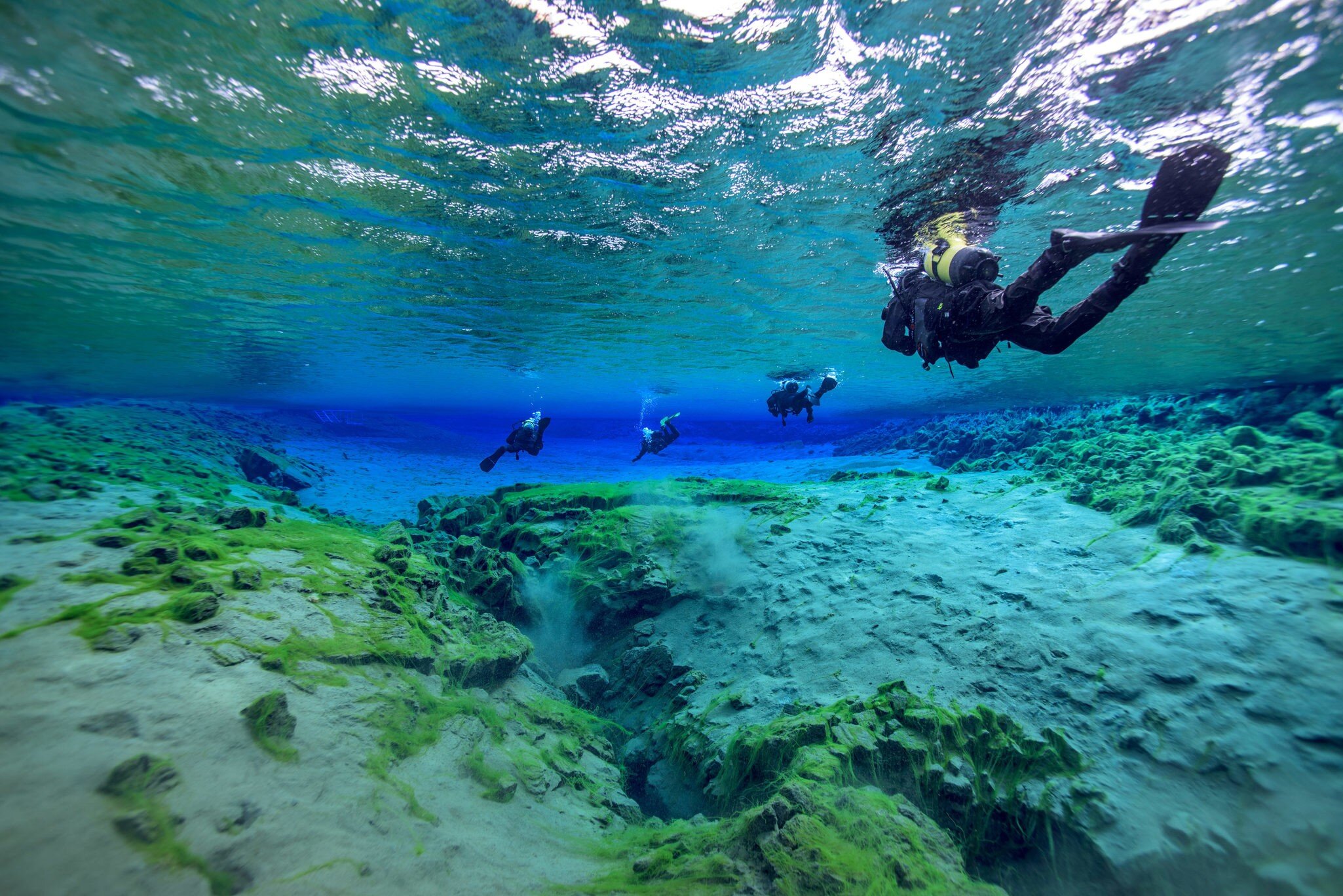 Man underwater diving in Þingvallavatn Lake along Silfra fissure, Iceland