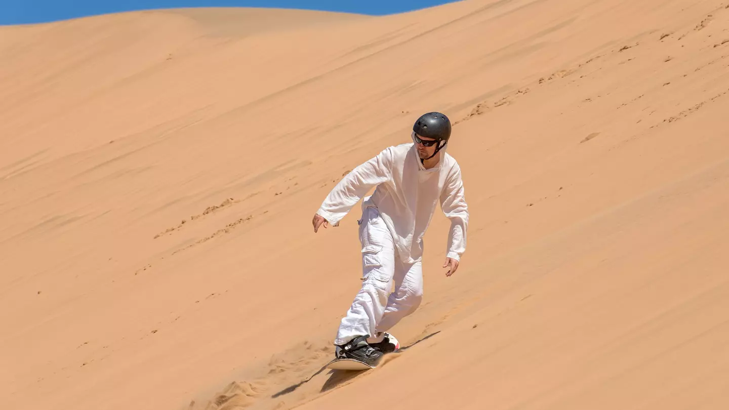 Sandboarder in action near Swakopmund, Namibia