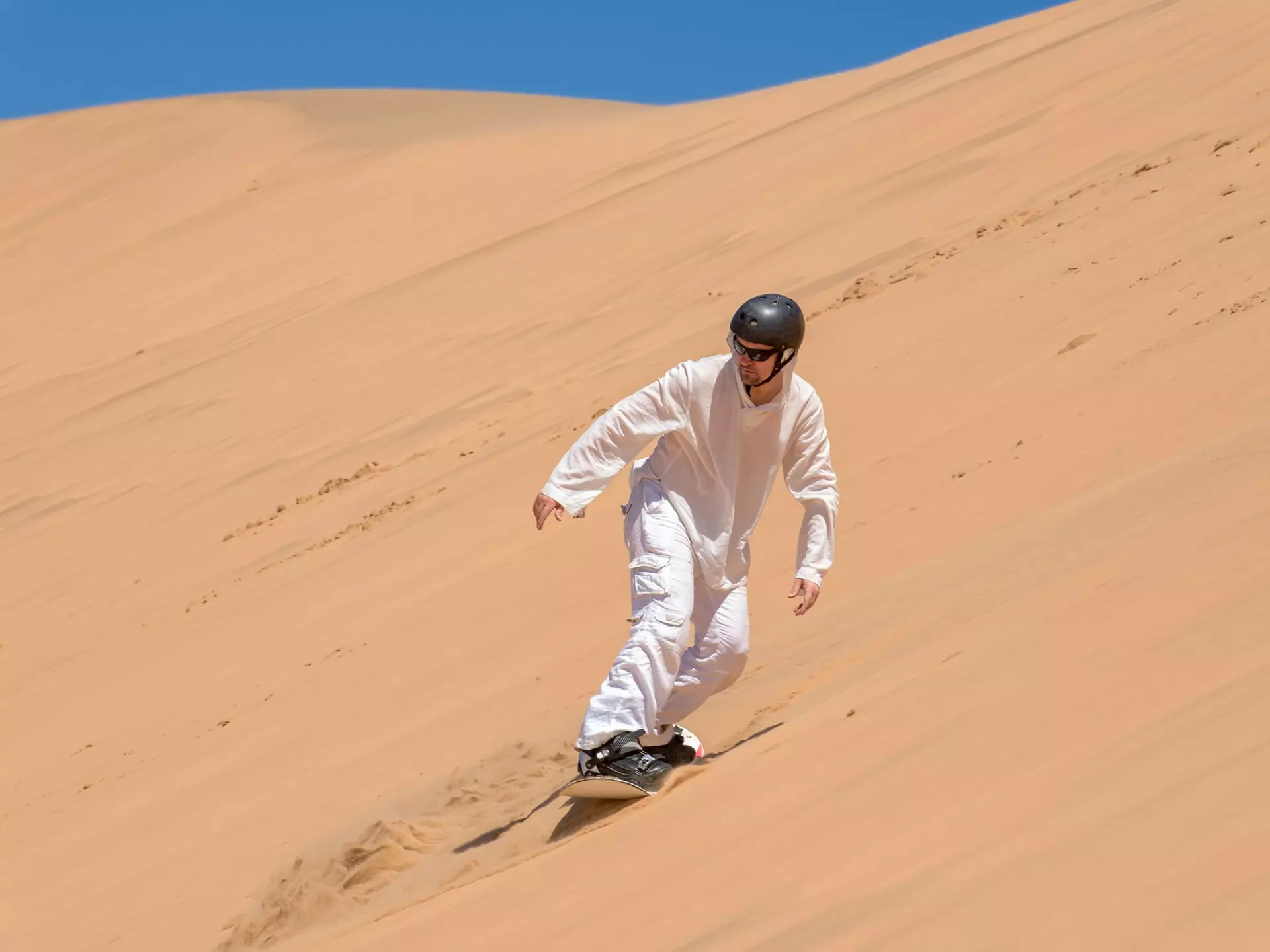 Sandboarder in action near Swakopmund, Namibia