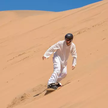 Sandboarder in action near Swakopmund, Namibia