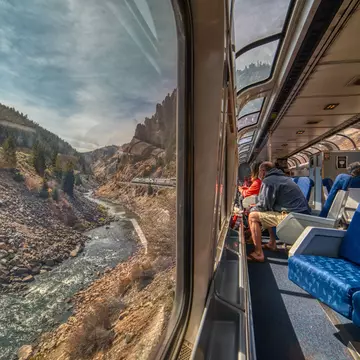 Train passengers crossing through the Rocky Mountains. Jacob Boomsma/Shutterstock