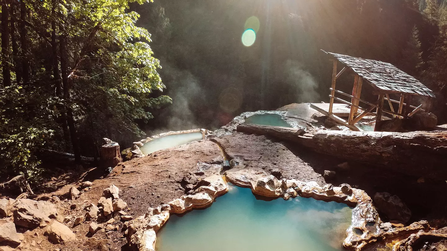 Umpqua Hot Springs in Southern Oregon are surrounded by beautiful forest. frankreporter via Getty Images