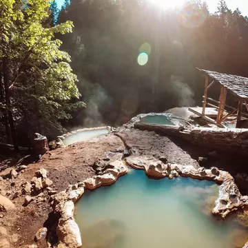 Umpqua Hot Springs in Southern Oregon are surrounded by beautiful forest. frankreporter via Getty Images