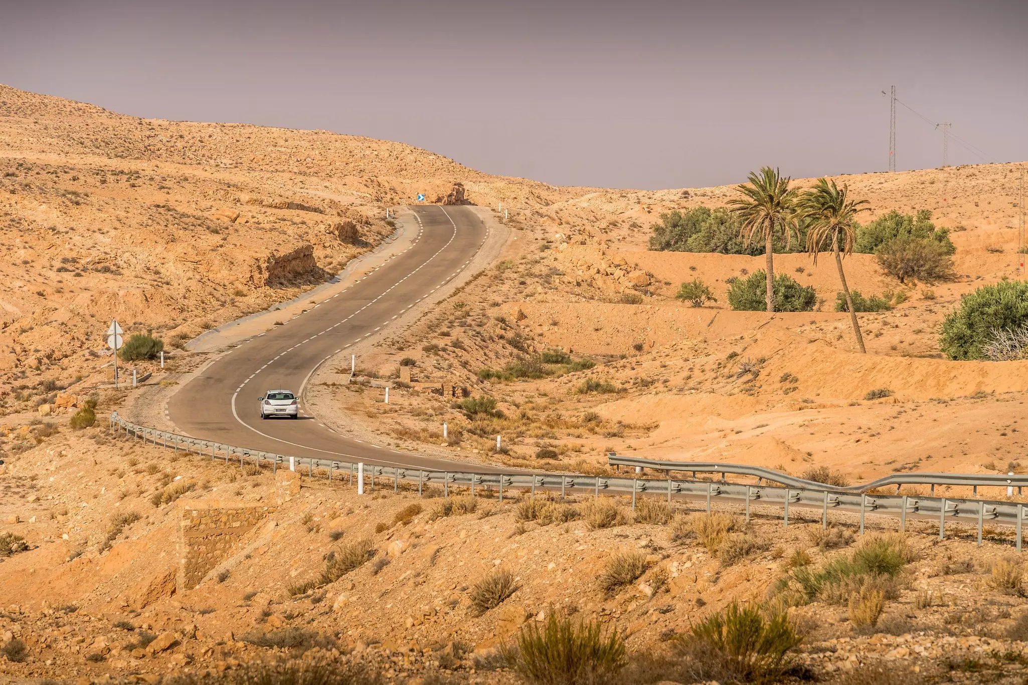 A car drives through the desert on the outskirts of Matmata, Tunisia.