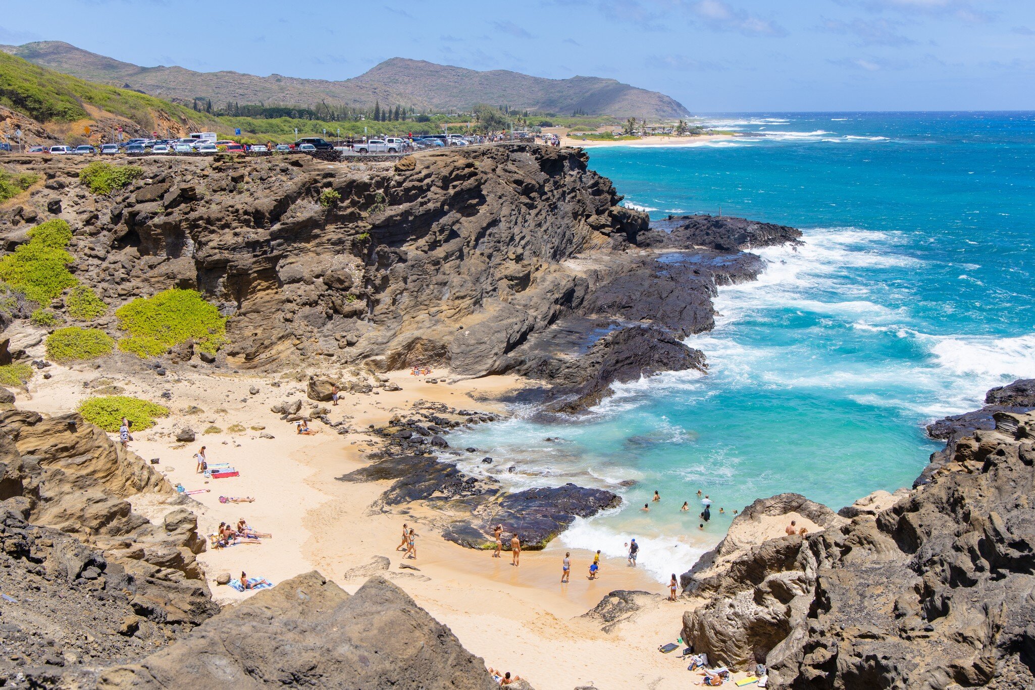 East Coast, Hawaii / USA - August 25 2019: Halona Beach Cove is a small sandy beach surrounded by rocky cove at Oahu southeast, it attracts people for swimming and suntanning while calm tides.