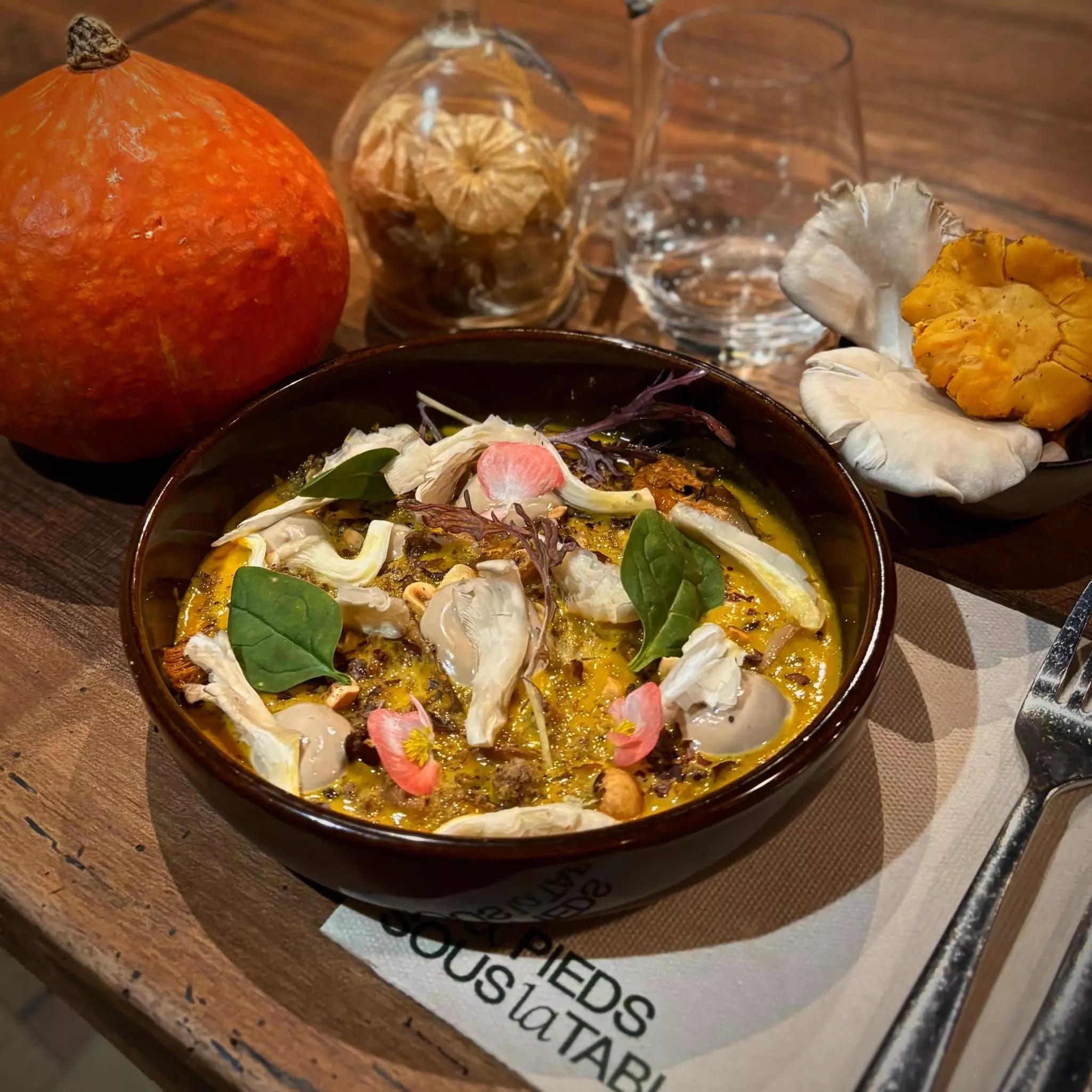 A pumpkin-based dish served in a round shallow bowl.